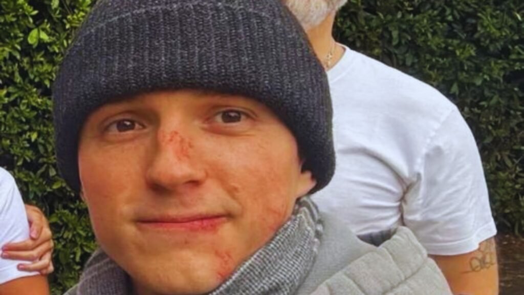 Actor Tom Holland in his Spider-Man costume on set, preparing for a stunt scene.