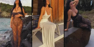 Kim Kardashian poses in a sheer black lace dress on the beach during her latest Instagram photoshoot.